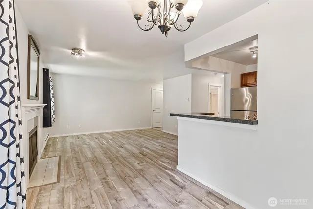 a view of a livingroom with a white painted wall and stairs