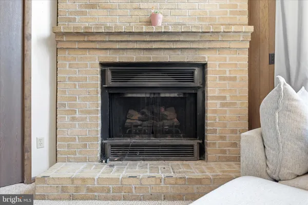 a living room with furniture a fireplace and a fireplace