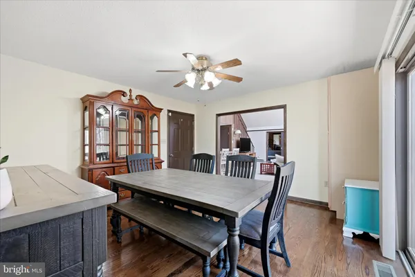 a view of a a dining room with furniture window and wooden floor