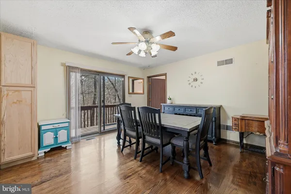 a kitchen that has a sink a refrigerator and a stove top oven with wooden floor