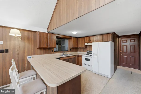 a kitchen with a sink cabinets and window