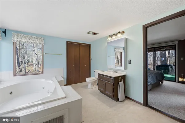 a white bath tub sitting in a bathroom next to a window