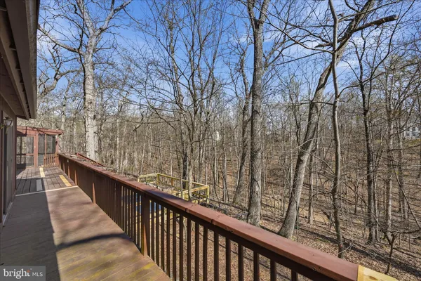 a view of deck with patio and wooden floor