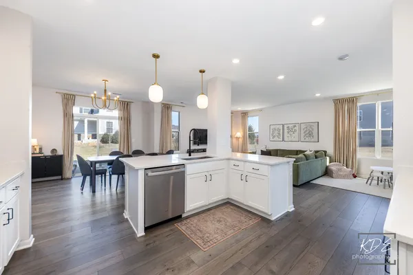 a large kitchen with cabinets a sink a counter space and dining table