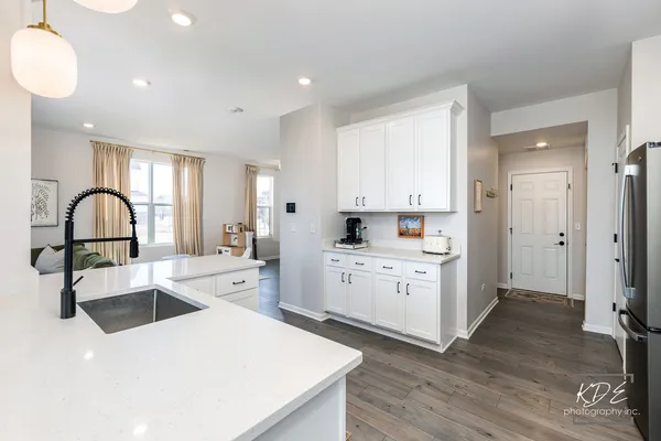 a kitchen with a sink cabinets and wooden floor