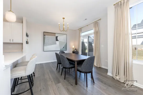 a view of a dining room with furniture and wooden floor