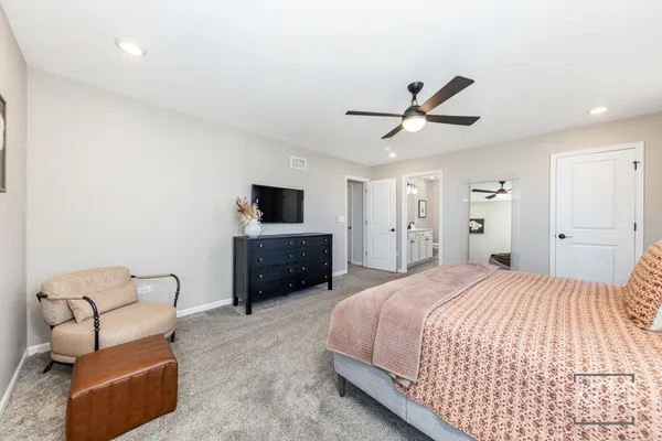 a spacious bedroom with a bed and furniture