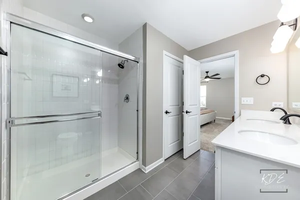a bathroom with a granite countertop sink mirror and shower