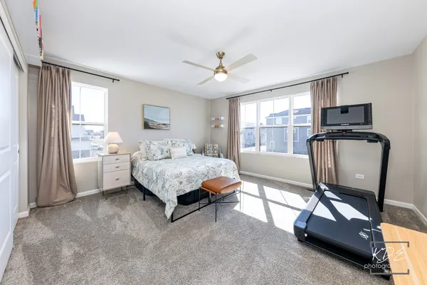 a bedroom with a bed dresser and a window