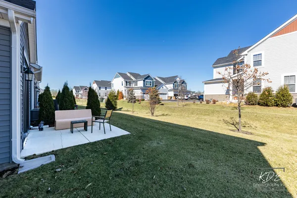 a view of a patio with a table and chairs