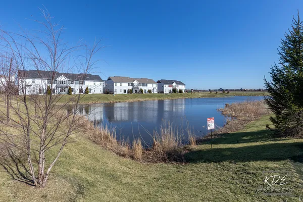 a view of a lake with houses in the back