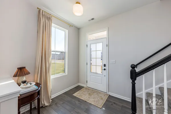 a bedroom with a window and wooden floor