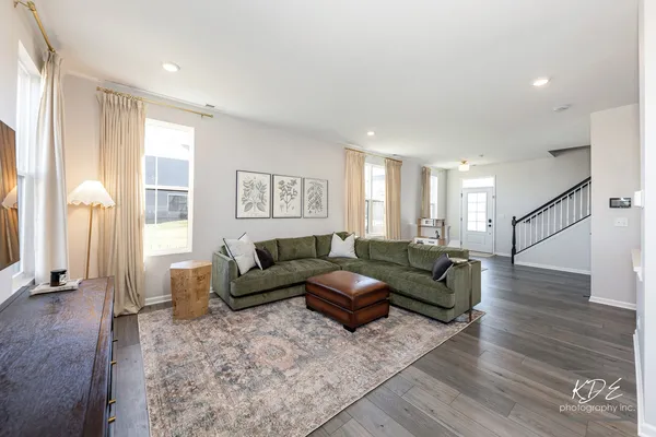 a living room with furniture and a wooden floor