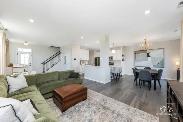 a living room with furniture and kitchen view
