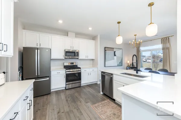 a kitchen with cabinets a sink and stainless steel appliances