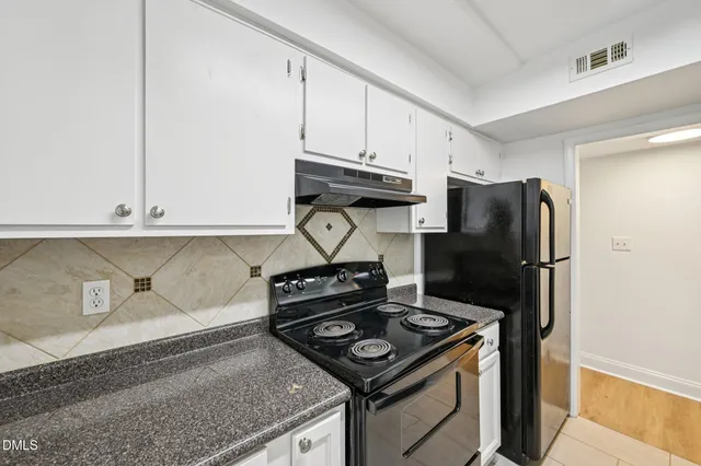 a kitchen with a stove and a refrigerator