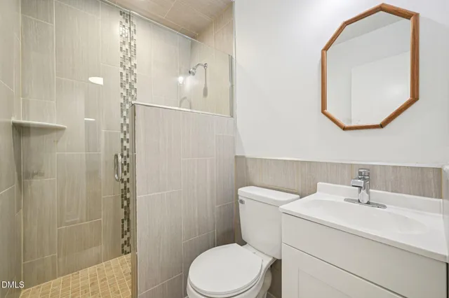 a bathroom with a sink a toilet and a mirror