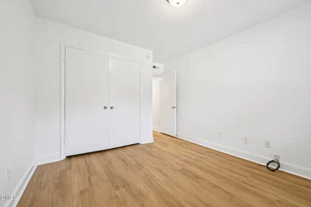 a view of a room with wooden floor