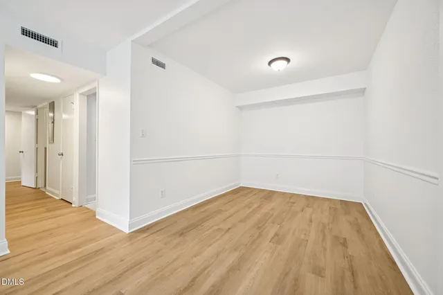 a view of a room with wooden floor