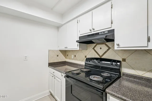 a stove top oven sitting inside of a kitchen
