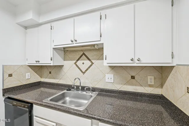 a kitchen with a sink and cabinets