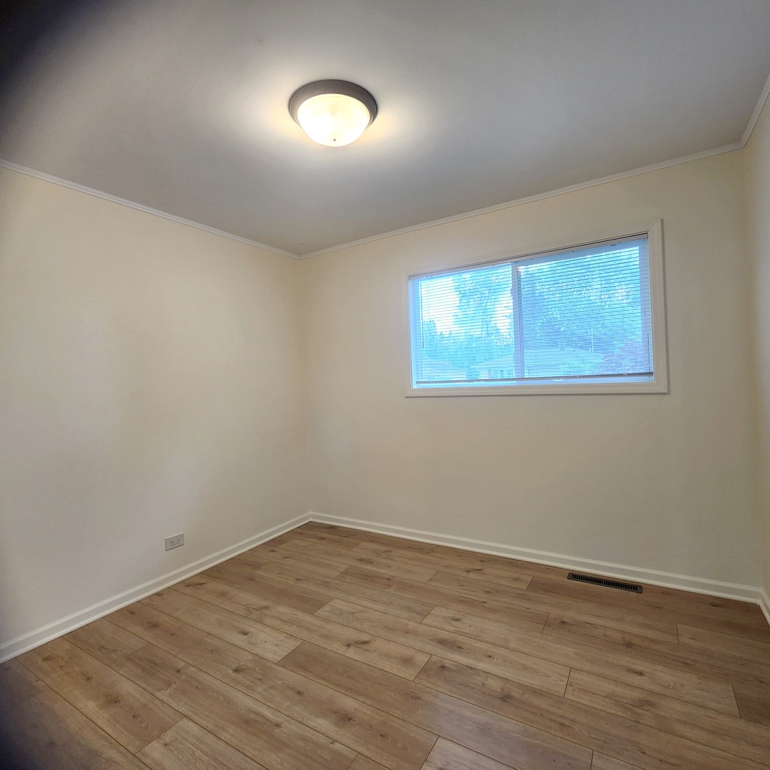 208 Albert Terrace Wheeling, IL 60090 - Photo 10 of 15 wooden floor in an empty room with a window