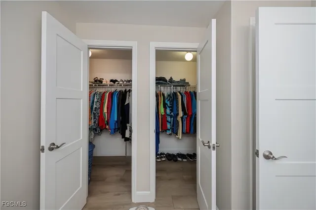 a walk in closet with a mirror