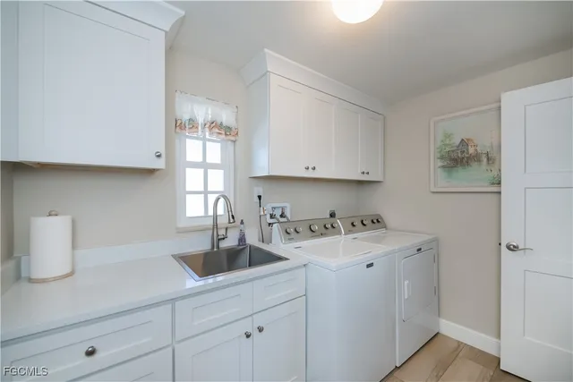a kitchen with a sink cabinets and window