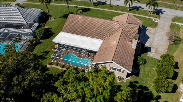 an aerial view of a house with a garden and lake view