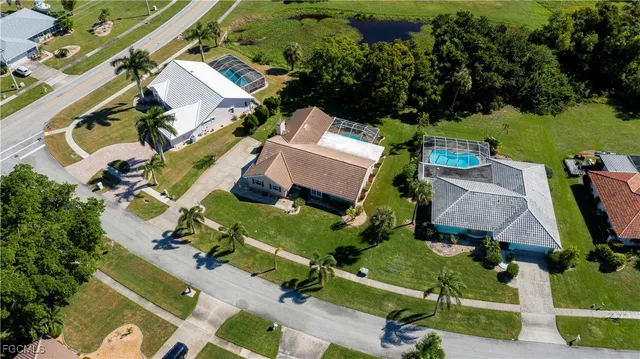 an aerial view of a house with a garden and yard