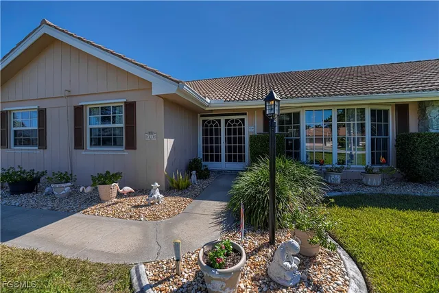 a front view of a house with garden