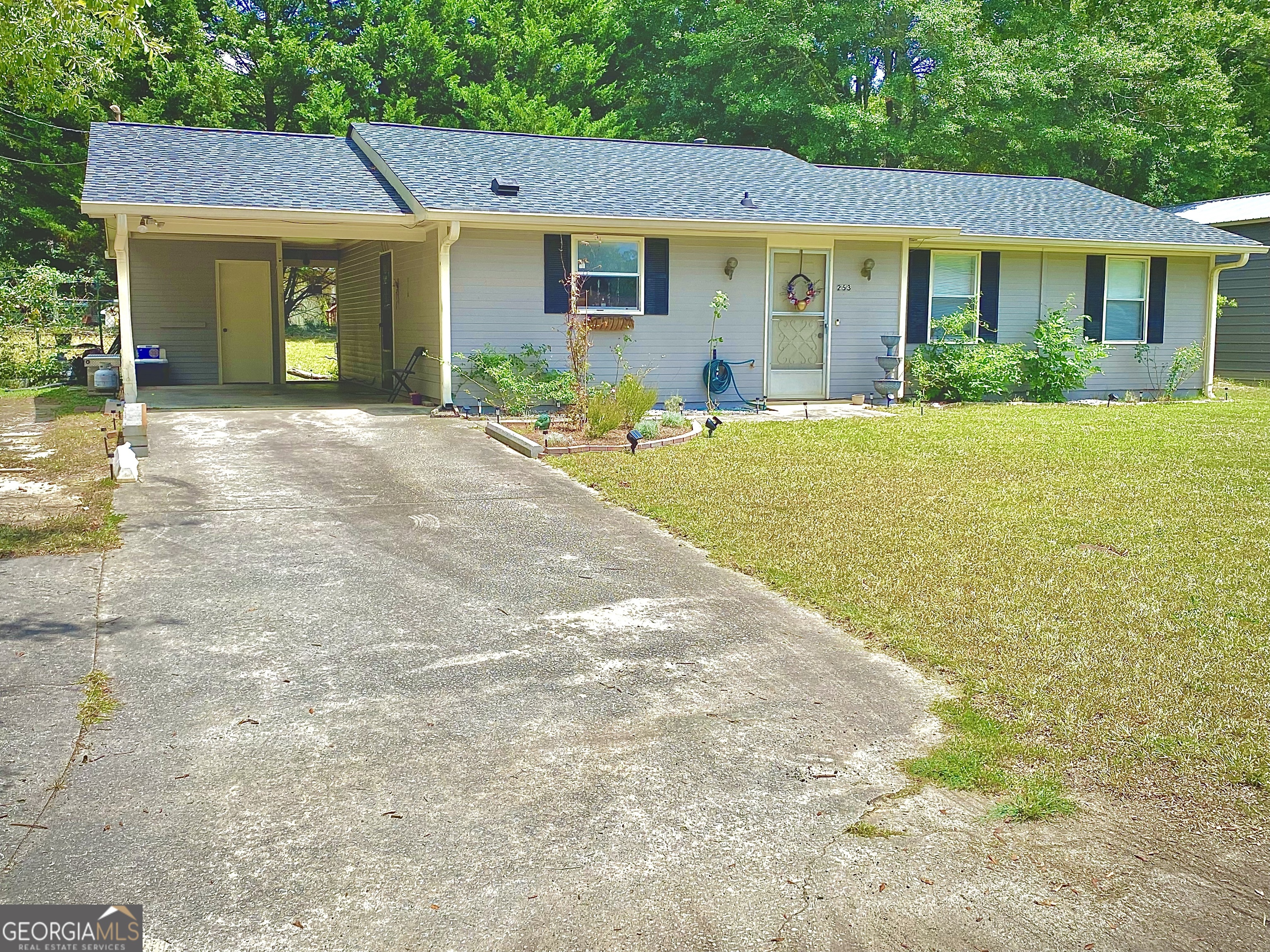 253 Stancil Drive Toccoa, GA 30577 - Photo 2 of 26 a front view of a house with a yard and potted plants