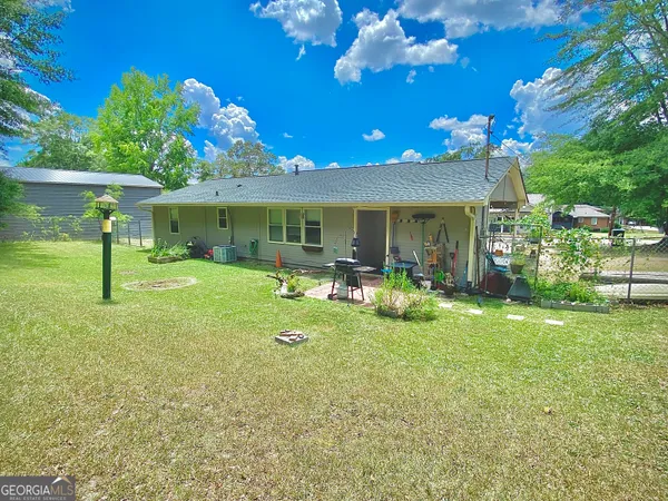 a view of a house with a backyard porch and sitting area