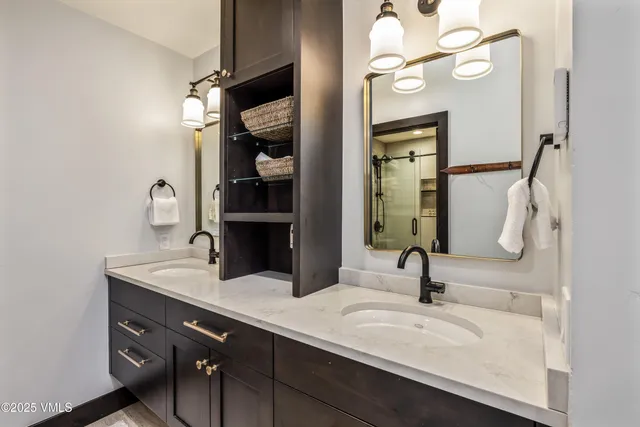 a bathroom with a double vanity sink and a mirror
