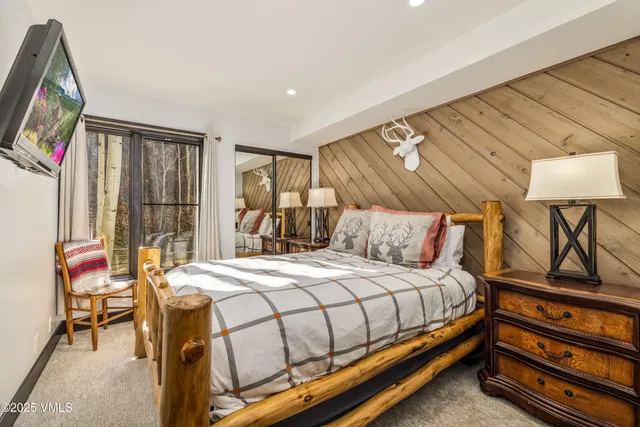 a bedroom with a bed and a tv on table