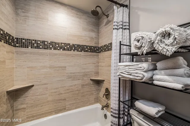 a bathroom with a bathtub and shower