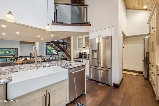 a kitchen with stainless steel appliances granite countertop a refrigerator and a sink