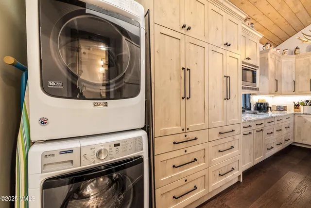 a utility room with granite countertop a washer and dryer