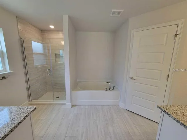 a bathroom with a bathtub and a shower