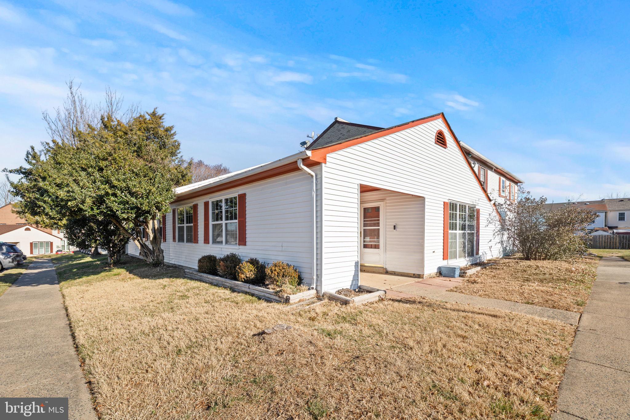 a view of a house with a yard covered in snow