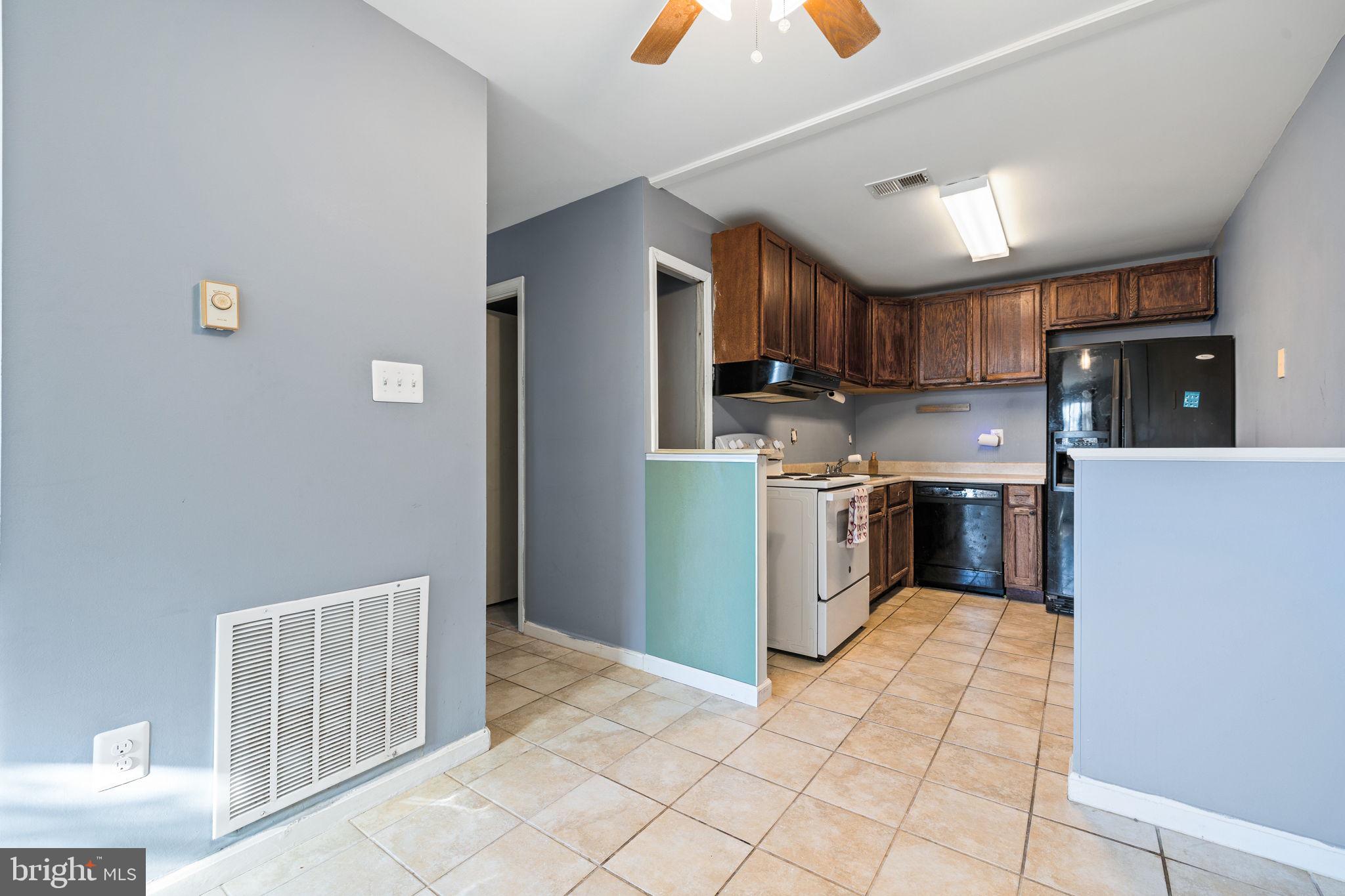 7699 Callan Drive Manassas, VA 20109 - Photo 5 of 11 a kitchen with stainless steel appliances granite countertop a stove top oven a sink dishwasher and a refrigerator