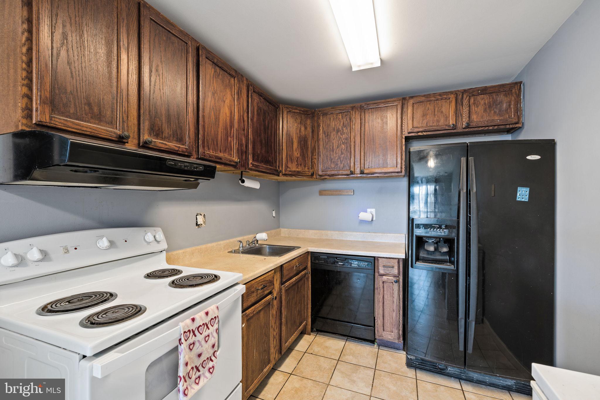 7699 Callan Drive Manassas, VA 20109 - Photo 6 of 11 a kitchen with a sink a stove and cabinets