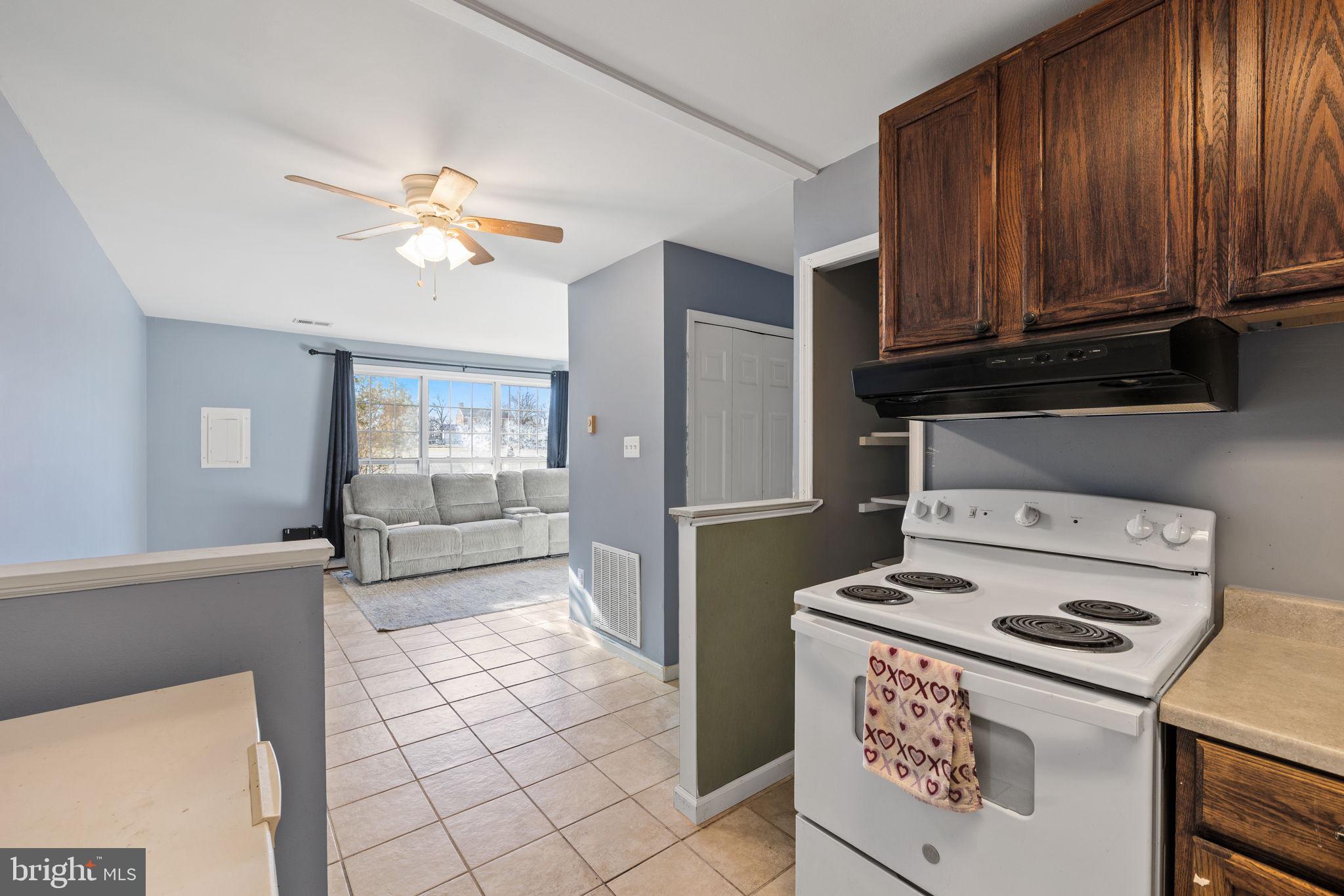 7699 Callan Drive Manassas, VA 20109 - Photo 7 of 11 a kitchen with a stove a refrigerator and a cabinets
