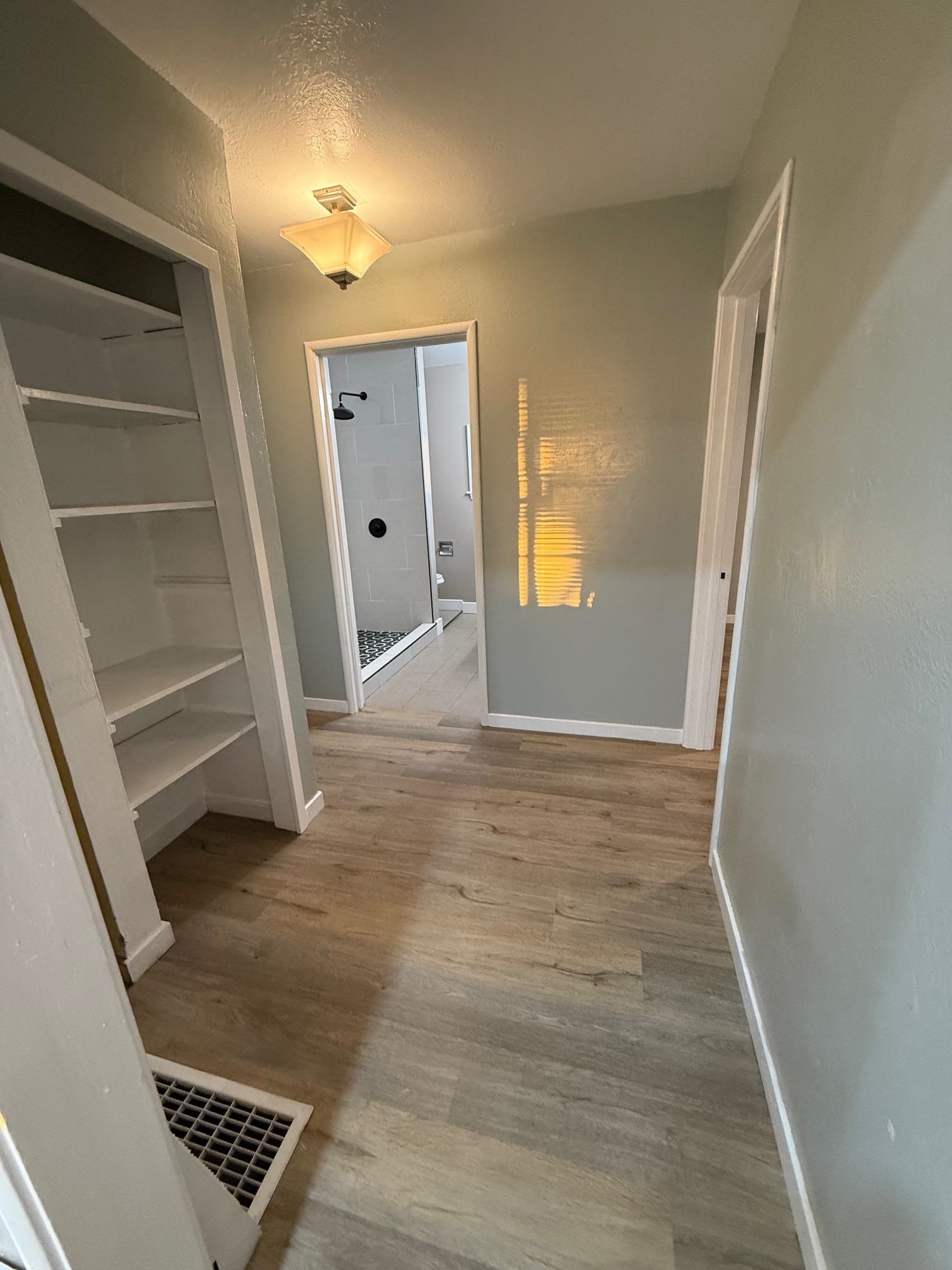 17028 Santa Fe Street Hayward, CA 94541 - Photo 14 of 54 a view of an empty room with wooden floor and a window