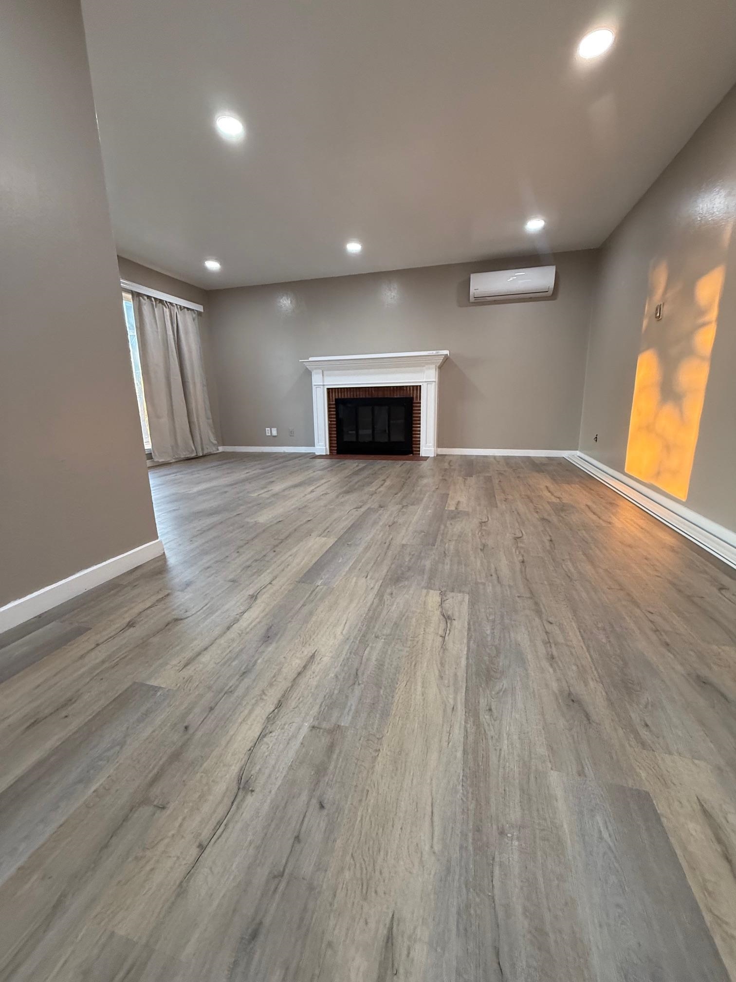 17028 Santa Fe Street Hayward, CA 94541 - Photo 15 of 54 a view of empty room with wooden floor and fireplace
