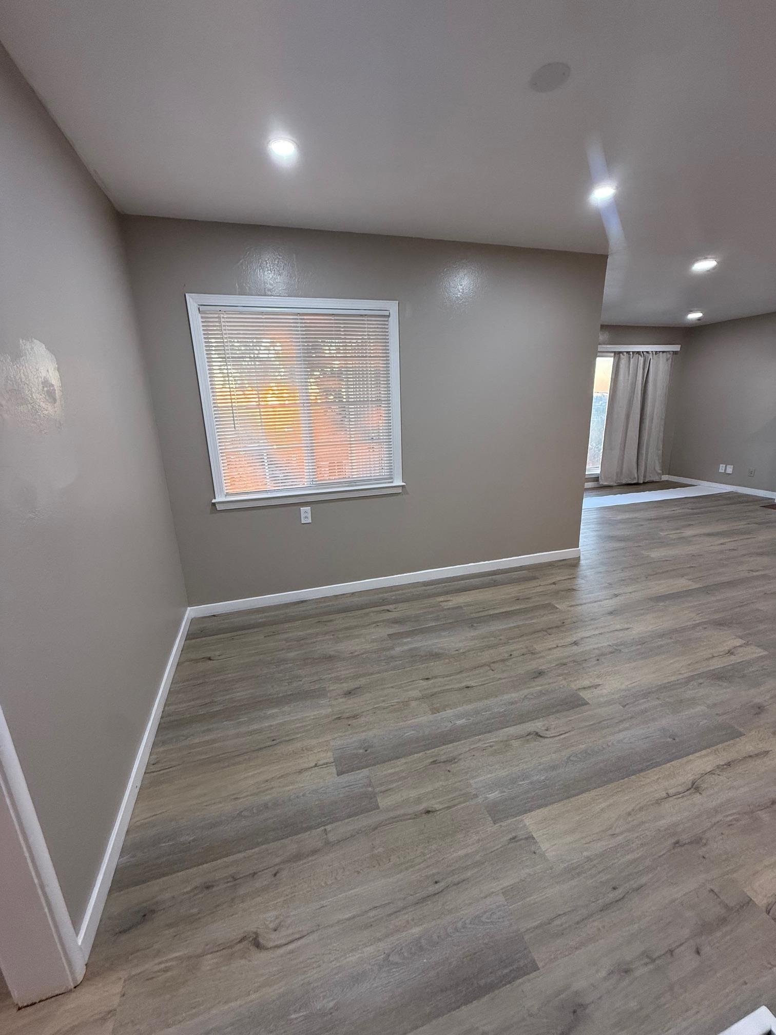 17028 Santa Fe Street Hayward, CA 94541 - Photo 21 of 54 an empty room with wooden floor and windows
