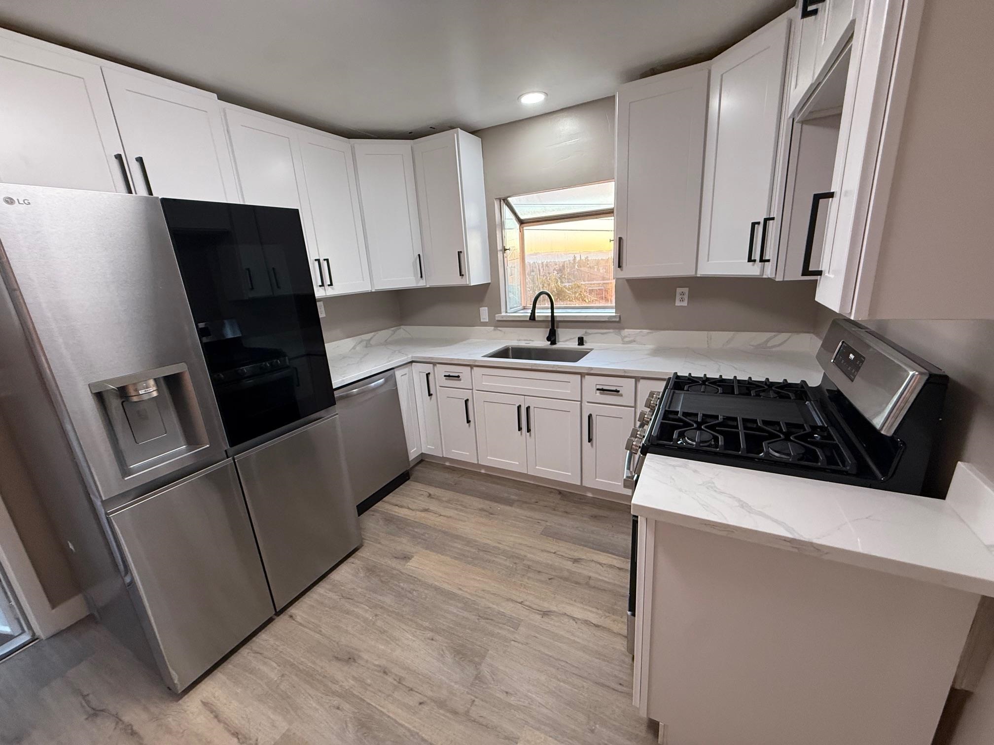 17028 Santa Fe Street Hayward, CA 94541 - Photo 26 of 54 a kitchen with a sink a stove and refrigerator