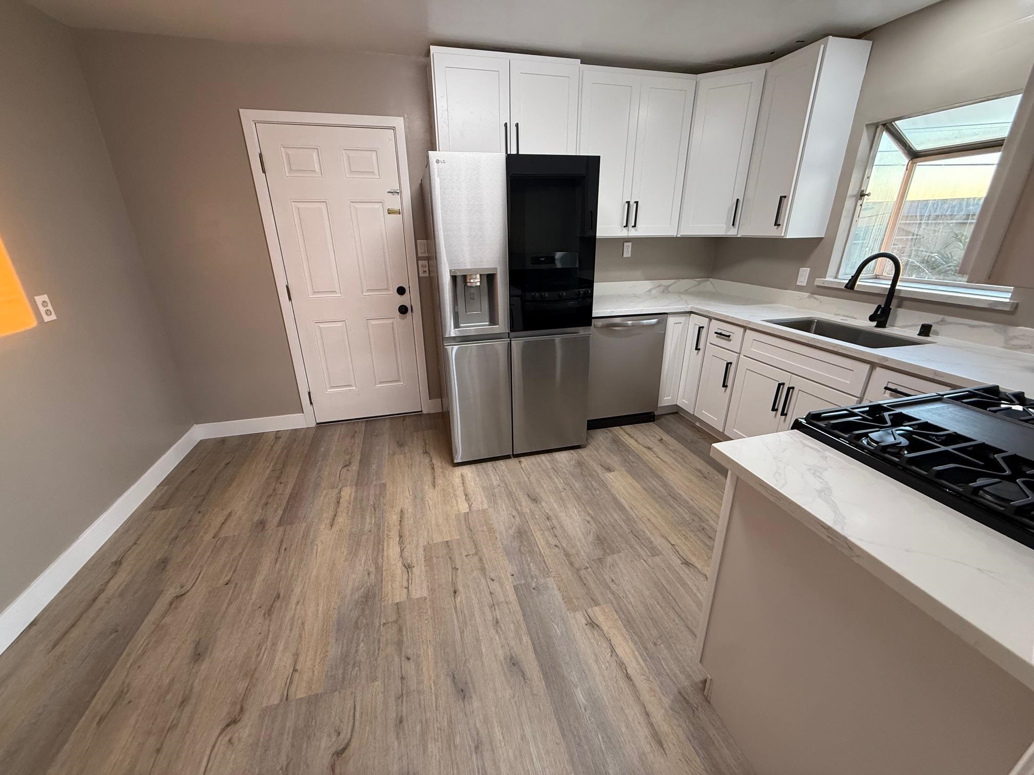 17028 Santa Fe Street Hayward, CA 94541 - Photo 28 of 54 a kitchen with wooden floors and appliances