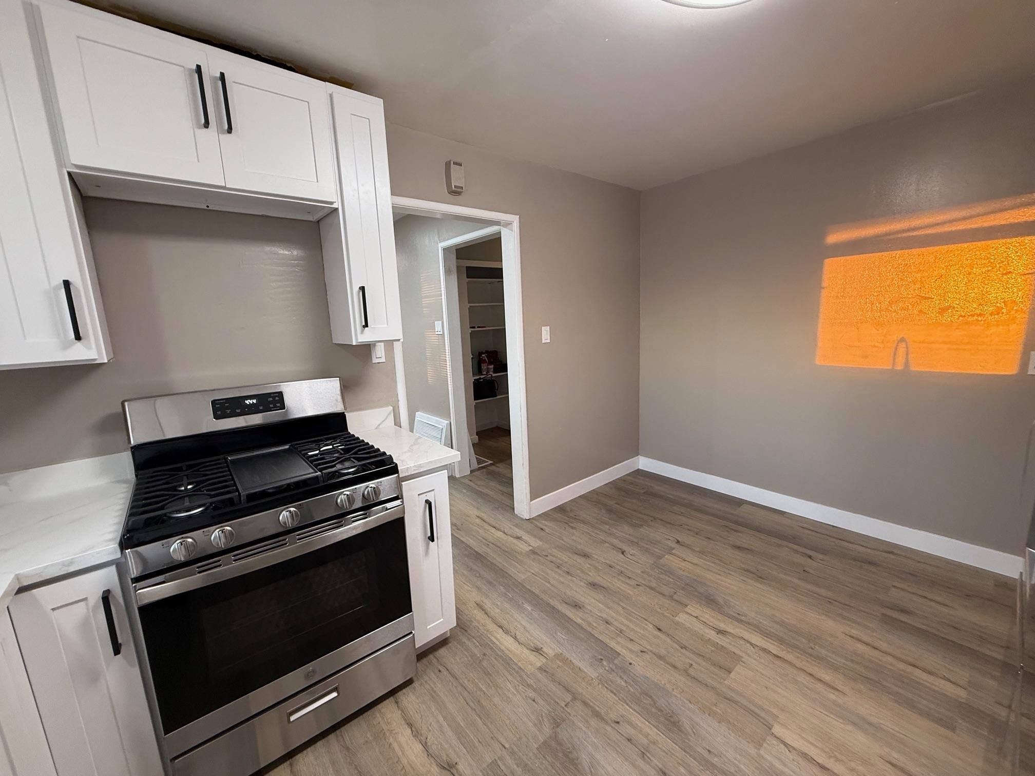 17028 Santa Fe Street Hayward, CA 94541 - Photo 30 of 54 a kitchen with granite countertop wooden floors and stainless steel appliances