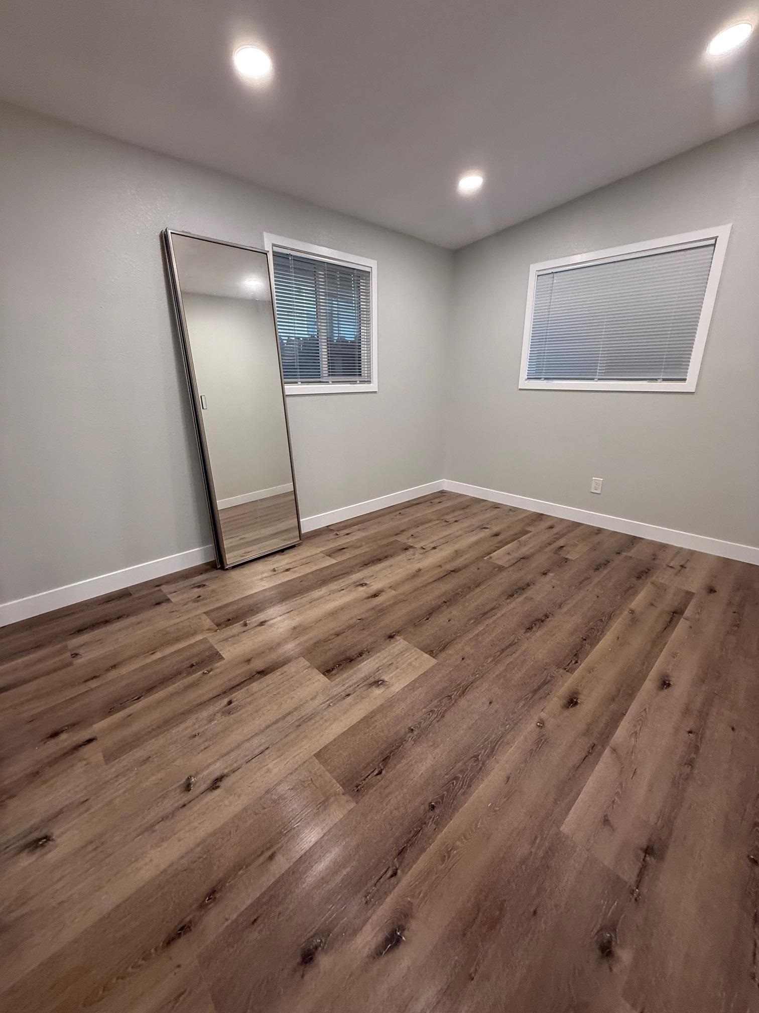 17028 Santa Fe Street Hayward, CA 94541 - Photo 36 of 54 a view of an empty room with wooden floor and a window